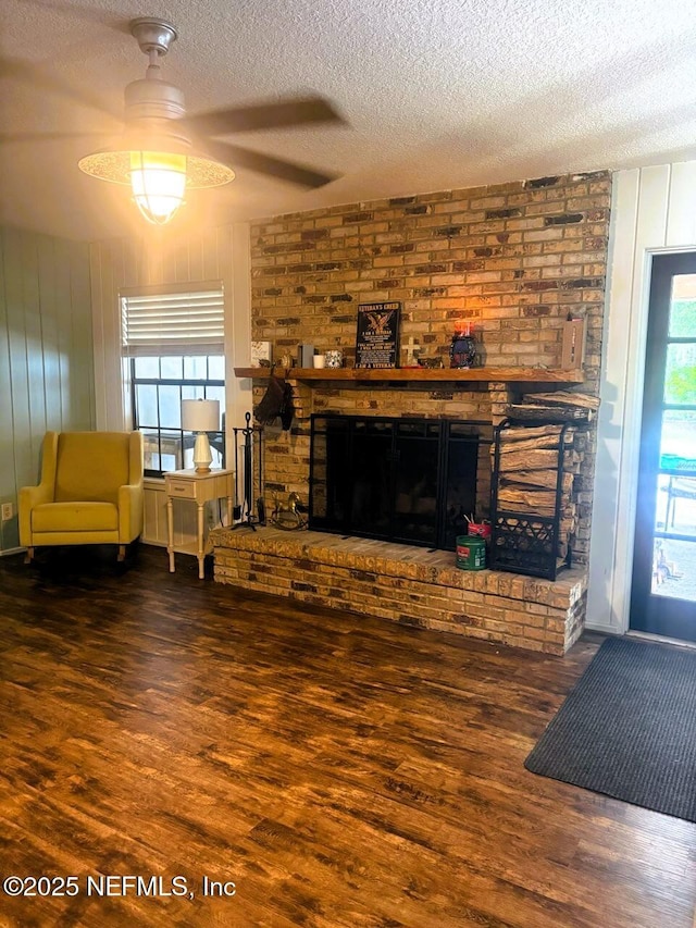 114 Timber Ln, Palatka, FL 32177 - living room featuring a fireplace, wood finished floors, a textured ceiling, and ceiling fan