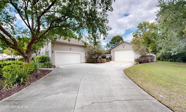 4637 Saddlehorn Trl, Middleburg, FL 32068 - view of front of property with a garage, a front lawn, driveway, and an outdoor structure