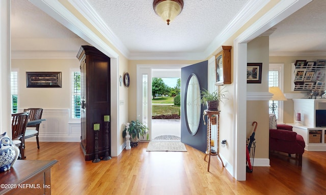 4637 Saddlehorn Trl, Middleburg, FL 32068 - entrance foyer with light wood finished floors, crown molding, and a textured ceiling