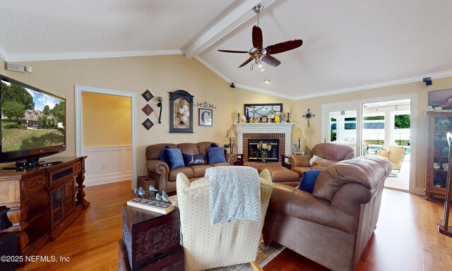 4637 Saddlehorn Trl, Middleburg, FL 32068 - living room with wood finished floors, ceiling fan, wainscoting, a fireplace, and ornamental molding