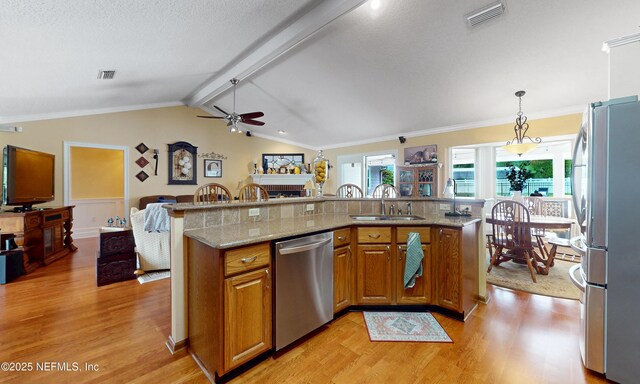 4637 Saddlehorn Trl, Middleburg, FL 32068 - kitchen featuring stainless steel appliances, light wood-style floors, a sink, a ceiling fan, and brown cabinetry