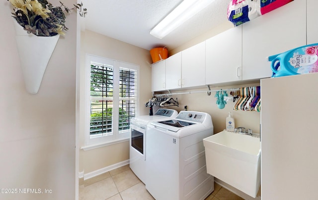 4637 Saddlehorn Trl, Middleburg, FL 32068 - laundry room featuring washing machine and clothes dryer, cabinet space, light tile patterned flooring, and baseboards