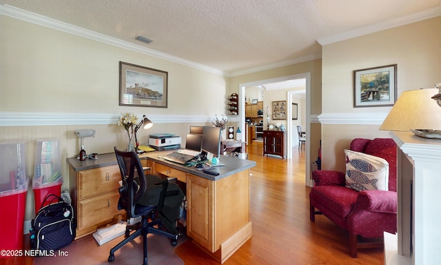 4637 Saddlehorn Trl, Middleburg, FL 32068 - home office with wood finished floors, ornamental molding, a wainscoted wall, and a textured ceiling