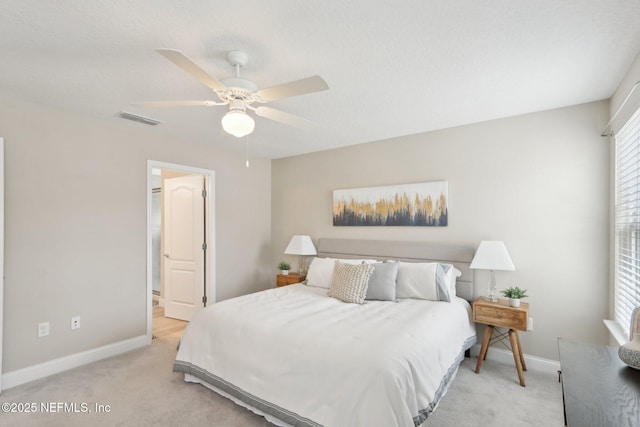 bedroom featuring baseboards, visible vents, a ceiling fan, and carpet
