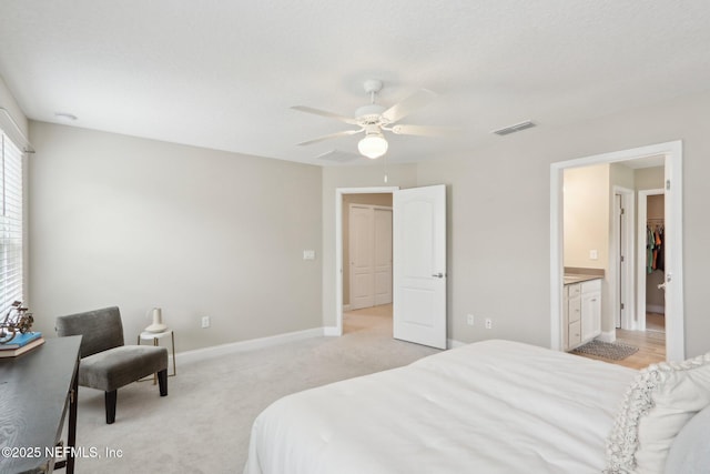 bedroom with baseboards, visible vents, a ceiling fan, and light colored carpet