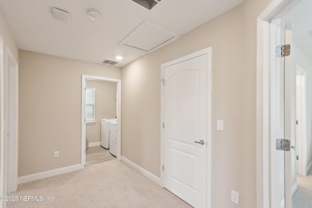interior space with attic access, visible vents, independent washer and dryer, and light carpet