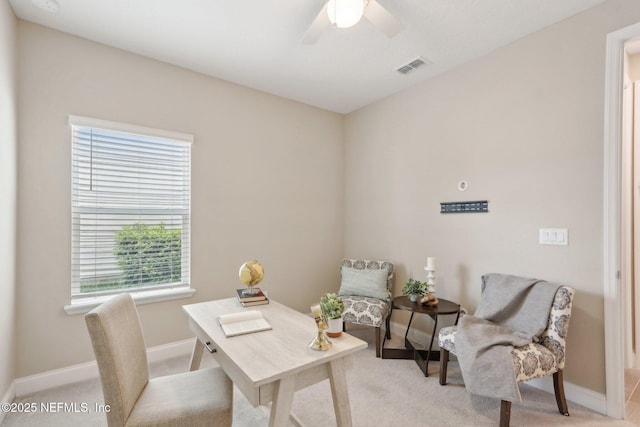 home office featuring visible vents, ceiling fan, baseboards, and light carpet