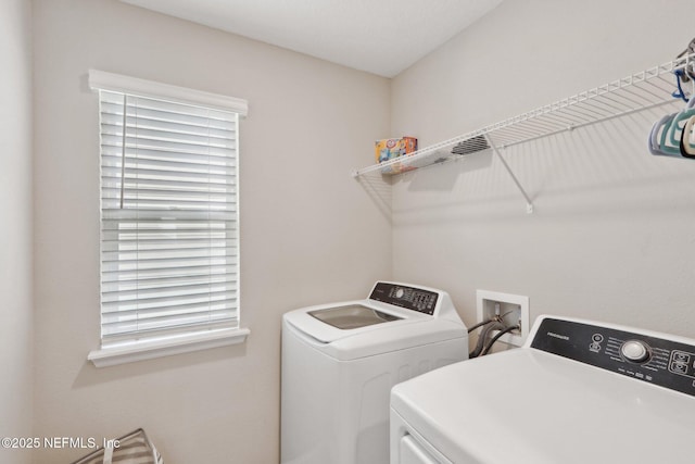 washroom with washing machine and dryer, laundry area, and plenty of natural light
