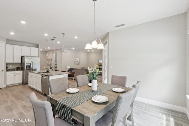 dining area featuring a notable chandelier, recessed lighting, visible vents, and wood finish floors