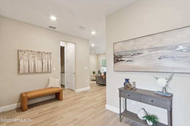 hallway with visible vents, light wood-type flooring, recessed lighting, and baseboards
