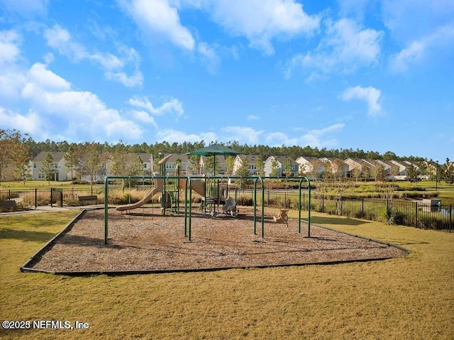 community play area with fence, a residential view, and a yard