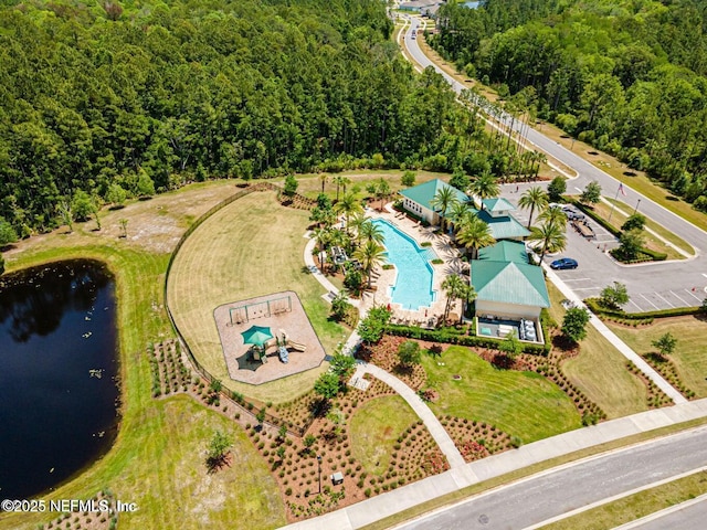 drone / aerial view with a water view and a view of trees