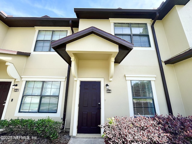 doorway to property with stucco siding