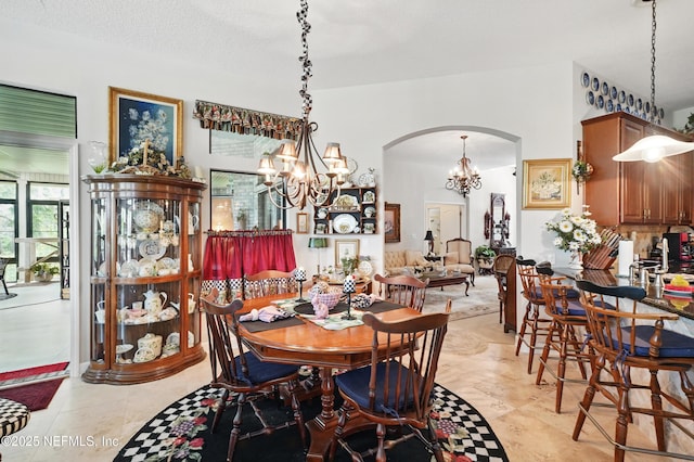 dining space featuring a chandelier and arched walkways