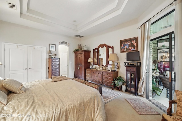 bedroom with visible vents, a closet, access to outside, and light carpet