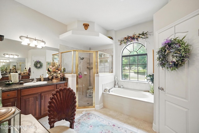 full bath with tile patterned floors, a stall shower, a garden tub, and vanity