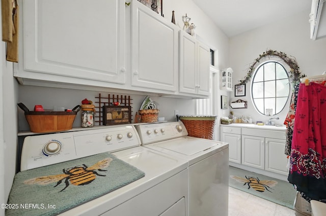 clothes washing area with cabinet space, separate washer and dryer, and a sink