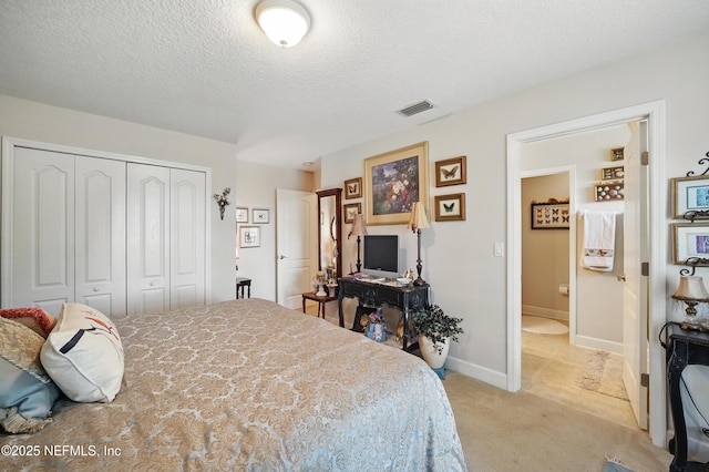 bedroom with a textured ceiling, visible vents, baseboards, a closet, and light carpet