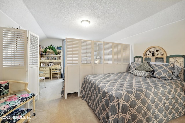 carpeted bedroom featuring a textured ceiling and vaulted ceiling