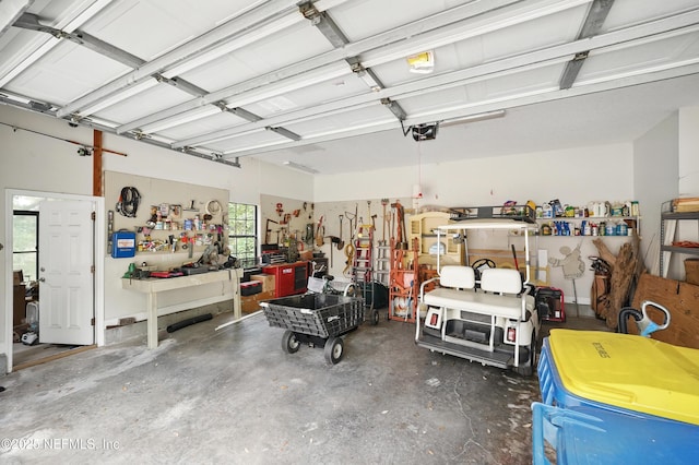 garage with a workshop area and a garage door opener