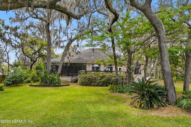 view of yard with a sunroom