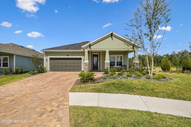 135 Neighbor Ct, Saint Augustine, FL 32092 - craftsman inspired home with covered porch, a front yard, a garage, decorative driveway, and stone siding