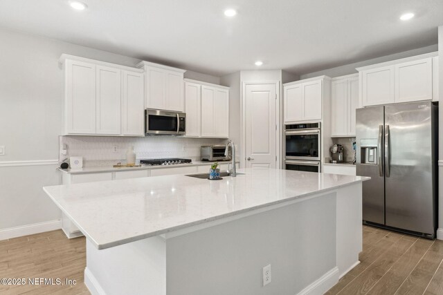 135 Neighbor Ct, Saint Augustine, FL 32092 - kitchen featuring a sink, light wood-style floors, stainless steel appliances, and backsplash