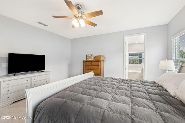 135 Neighbor Ct, Saint Augustine, FL 32092 - bedroom with ensuite bathroom, light carpet, ceiling fan, and visible vents