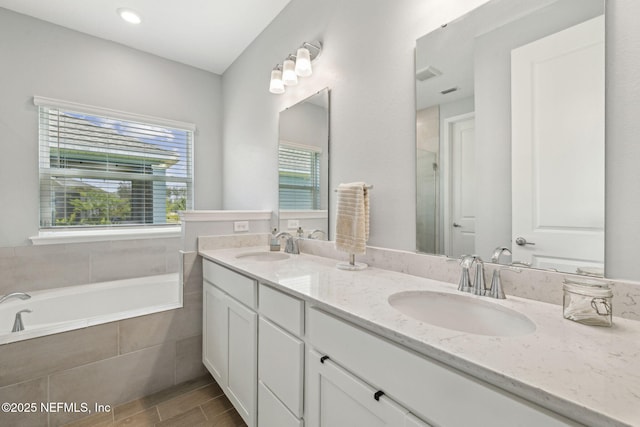 135 Neighbor Ct, Saint Augustine, FL 32092 - full bathroom with a sink, a shower with shower door, double vanity, and a relaxing tiled tub
