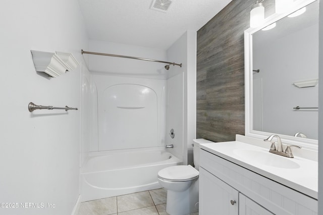 full bathroom with washtub / shower combination, visible vents, toilet, vanity, and tile patterned flooring
