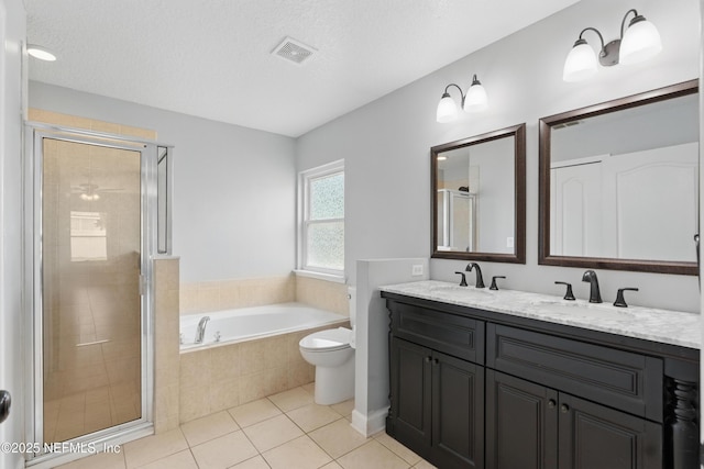 full bath with visible vents, a shower stall, a garden tub, and a sink