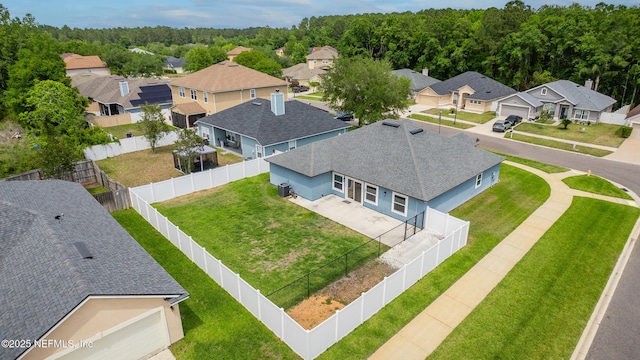 aerial view with a wooded view and a residential view