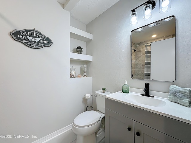 bathroom featuring vanity, toilet, and a shower with curtain