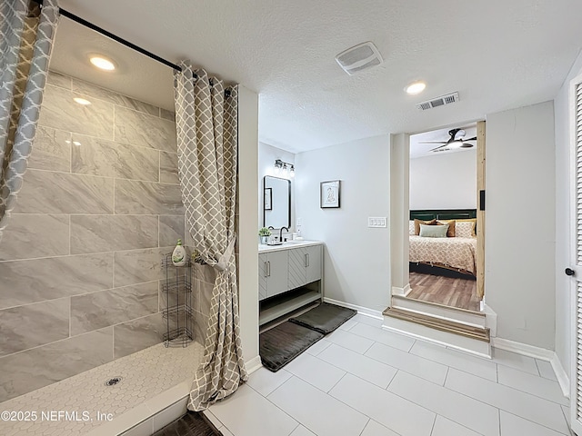full bathroom featuring visible vents, tiled shower, a ceiling fan, and ensuite bathroom