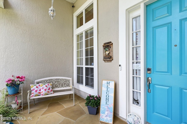 1695 Waters Edge Dr, Fleming Island, FL 32003 - view of exterior entry featuring a porch and stucco siding