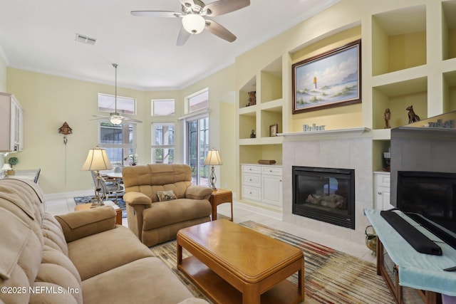 1695 Waters Edge Dr, Fleming Island, FL 32003 - living area featuring visible vents, a fireplace, baseboards, ceiling fan, and built in shelves
