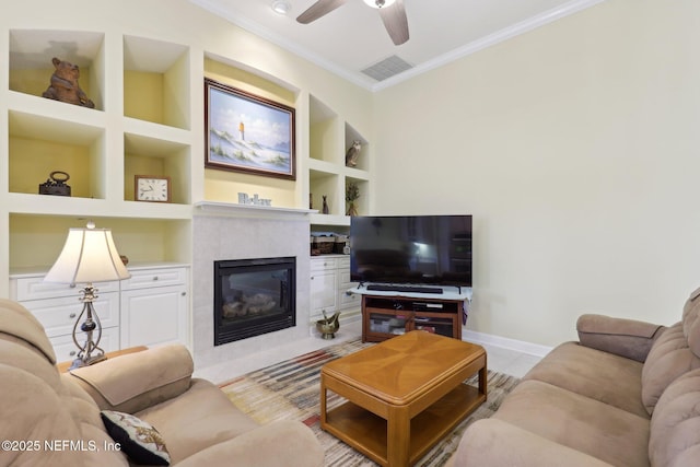 1695 Waters Edge Dr, Fleming Island, FL 32003 - living area featuring ceiling fan, built in shelves, a tiled fireplace, baseboards, and ornamental molding