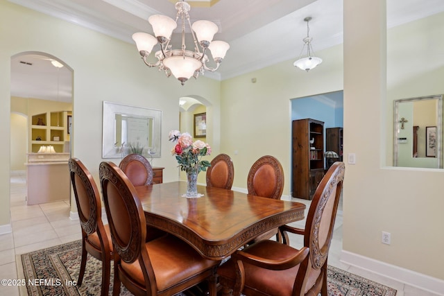 1695 Waters Edge Dr, Fleming Island, FL 32003 - dining room with crown molding, light tile patterned flooring, arched walkways, a chandelier, and baseboards