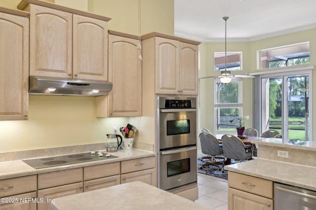 1695 Waters Edge Dr, Fleming Island, FL 32003 - kitchen with light countertops, under cabinet range hood, appliances with stainless steel finishes, and light brown cabinetry