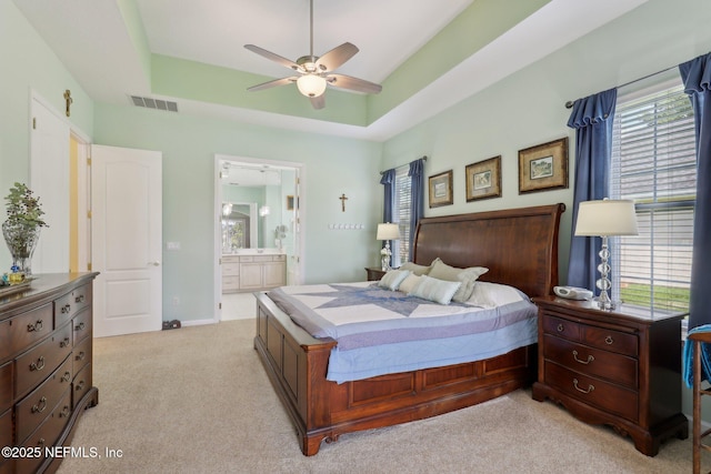 1695 Waters Edge Dr, Fleming Island, FL 32003 - bedroom featuring visible vents, ensuite bath, multiple windows, and light colored carpet