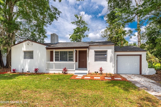 single story home with covered porch, a garage, a front lawn, and stucco siding