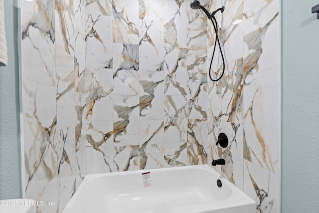 full bathroom featuring shower / washtub combination and a textured wall
