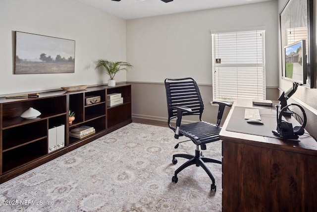home office with baseboards and a ceiling fan