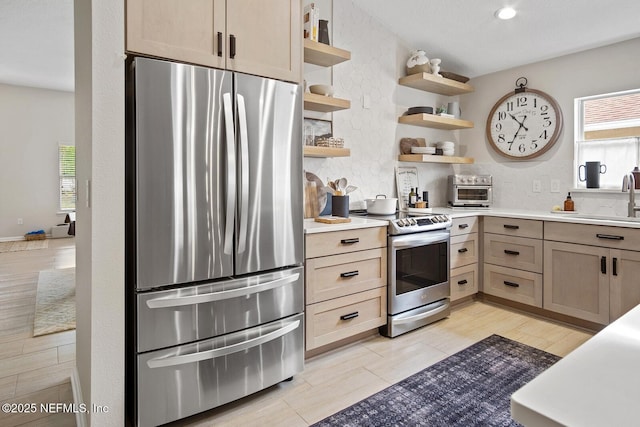kitchen featuring open shelves, a sink, appliances with stainless steel finishes, and backsplash