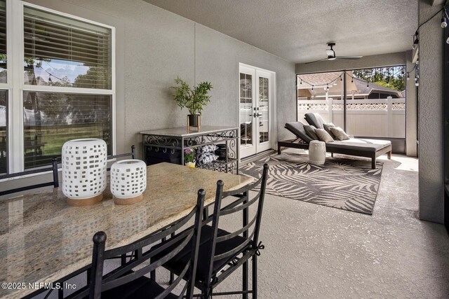 view of patio / terrace with outdoor dining area, fence, and french doors