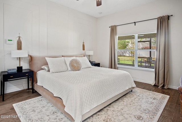 bedroom with baseboards, a ceiling fan, and wood finished floors
