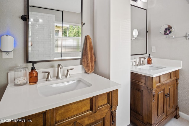 full bathroom with a sink and two vanities