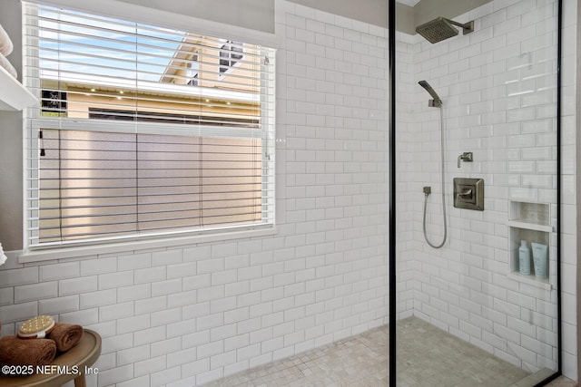 full bath featuring a tile shower