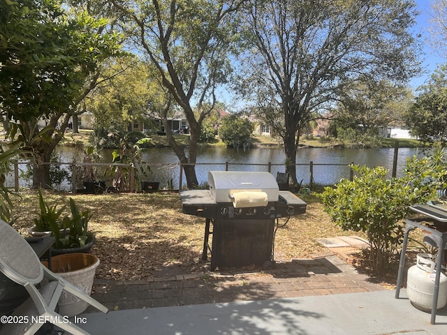 view of yard with fence and a water view