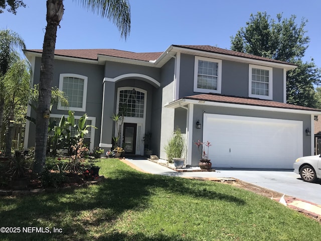 traditional-style home featuring an attached garage, stucco siding, driveway, and a front yard